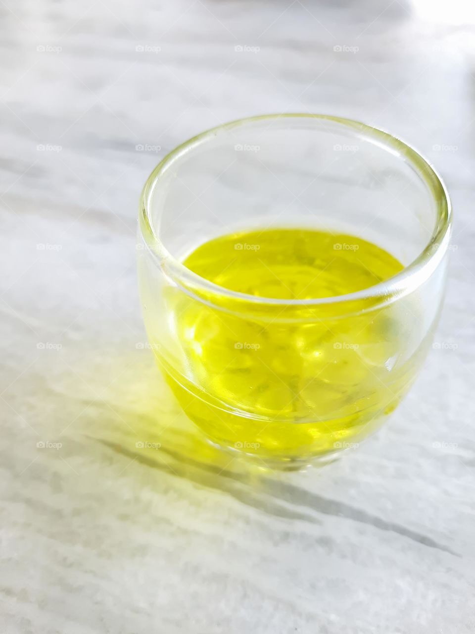 A glass of yellow Colored fruit juice