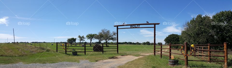 The Wolff Ranch....hay across the field with a decorated gate...I love fall!