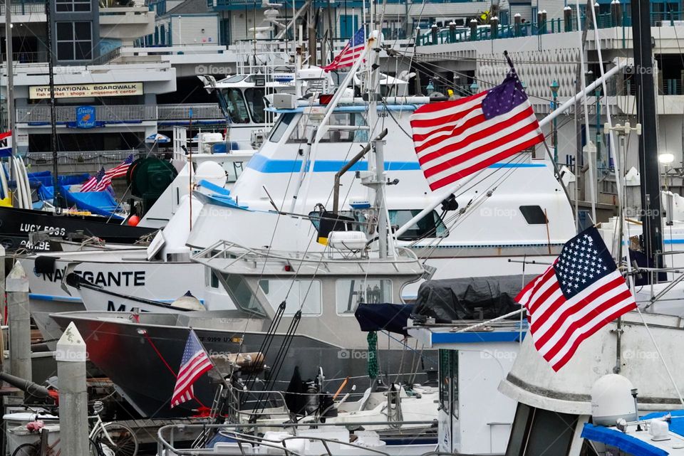 Small boats dock and fly an array of flags