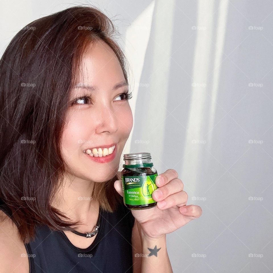 Asian woman in Chicken essence for energy of the day 