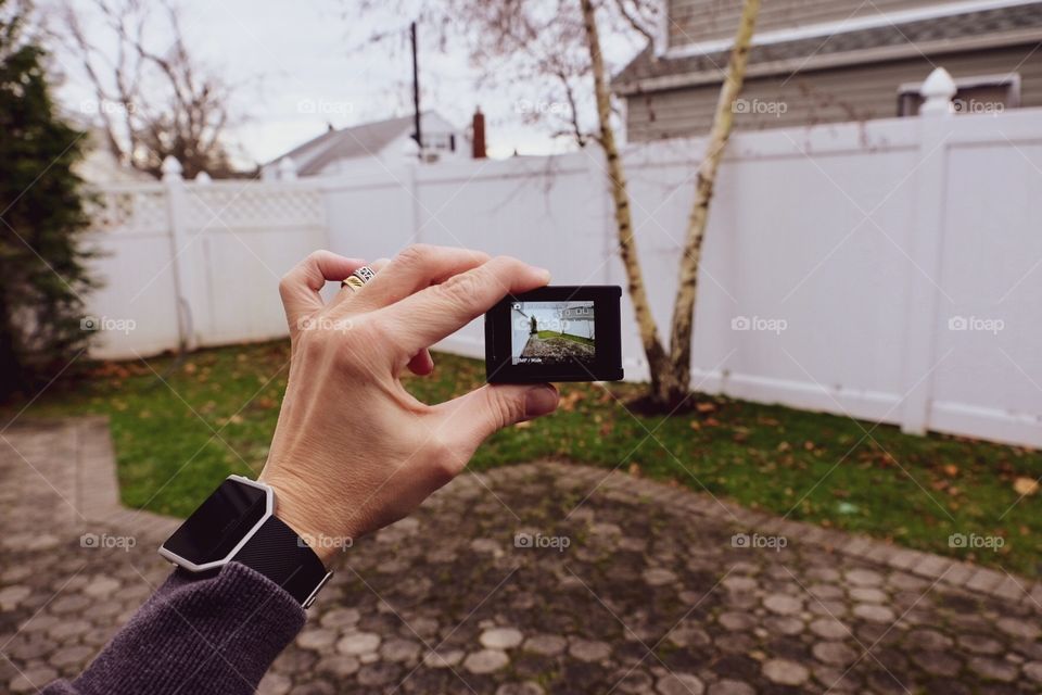 Hand Holding Go Pro Hero 4, Person Using An Action Camera, Showing Perspective Of A Go Pro Hero 4 Camera