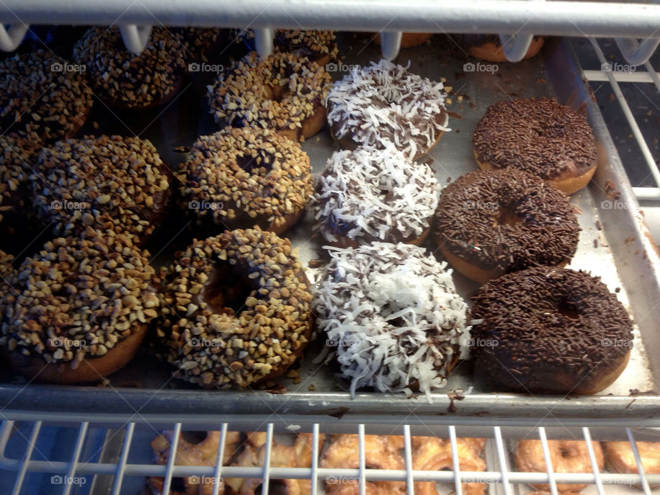 Doughnuts in a bakery case