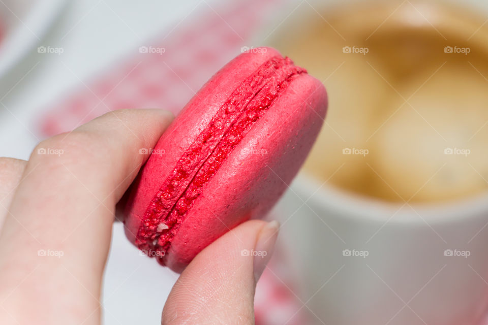 Extreme close-up of macaroon in hand