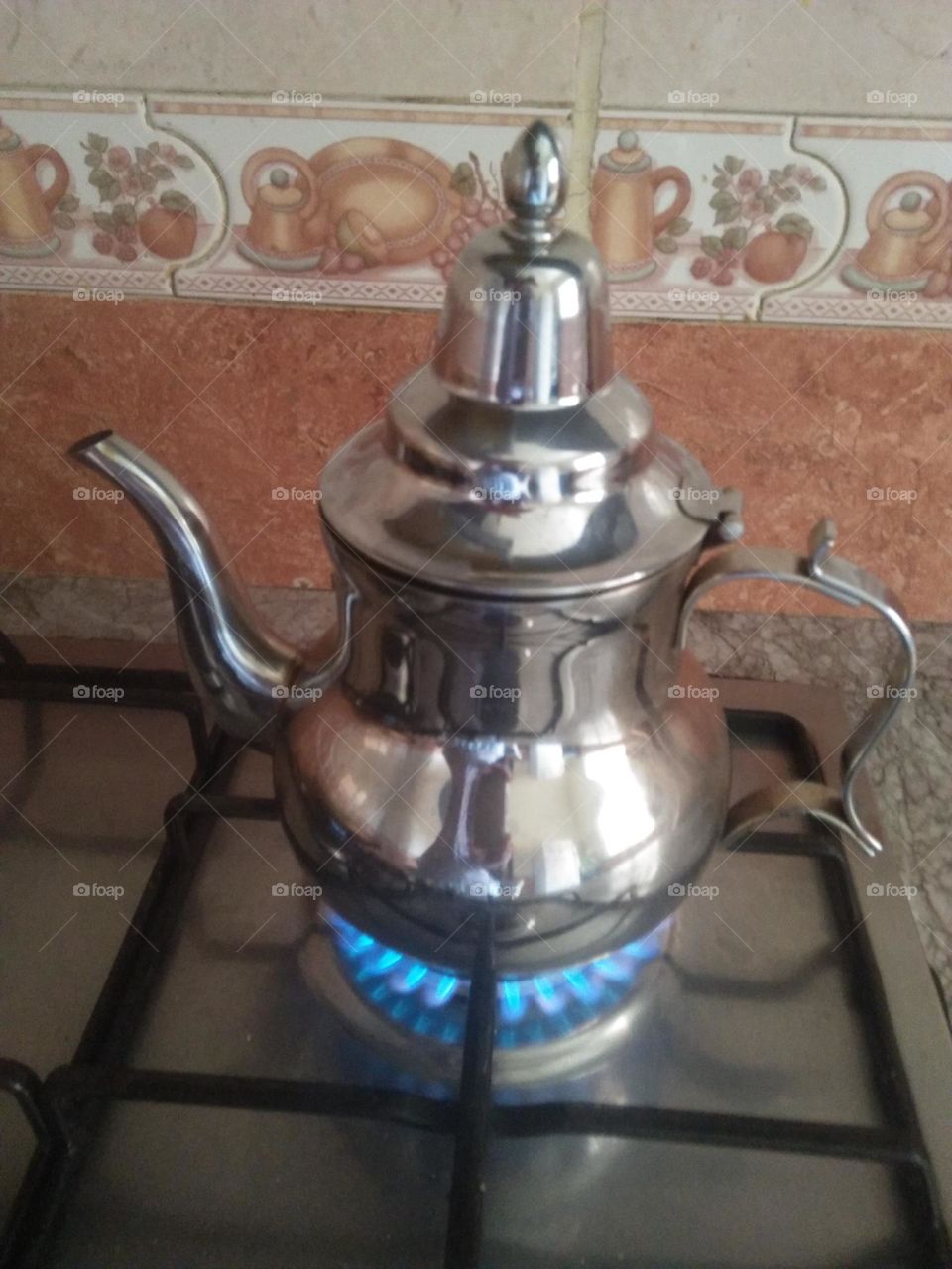 Tea caddy above stove.