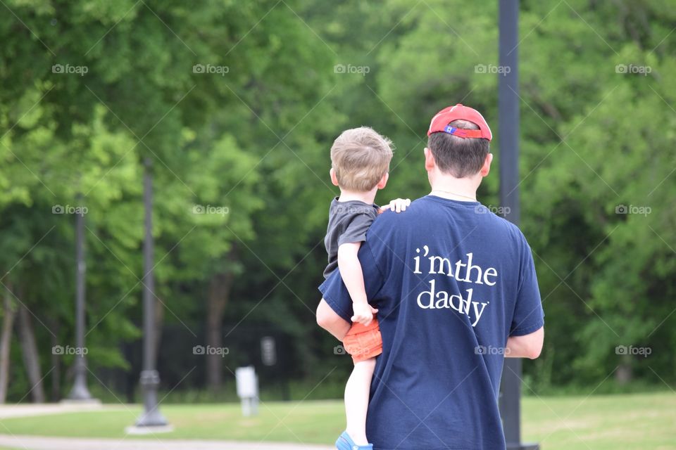 Dad carrying his son