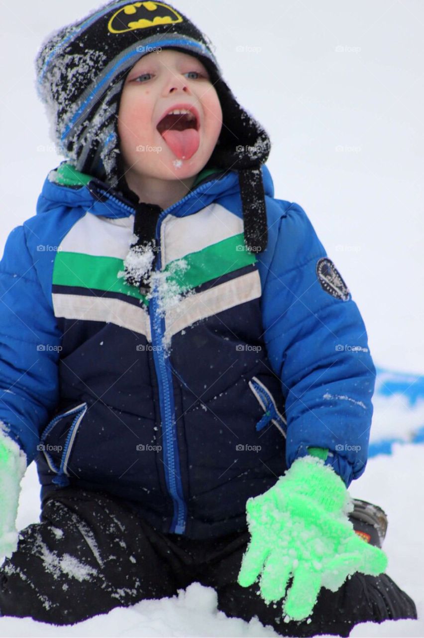 Boy sitting in snow