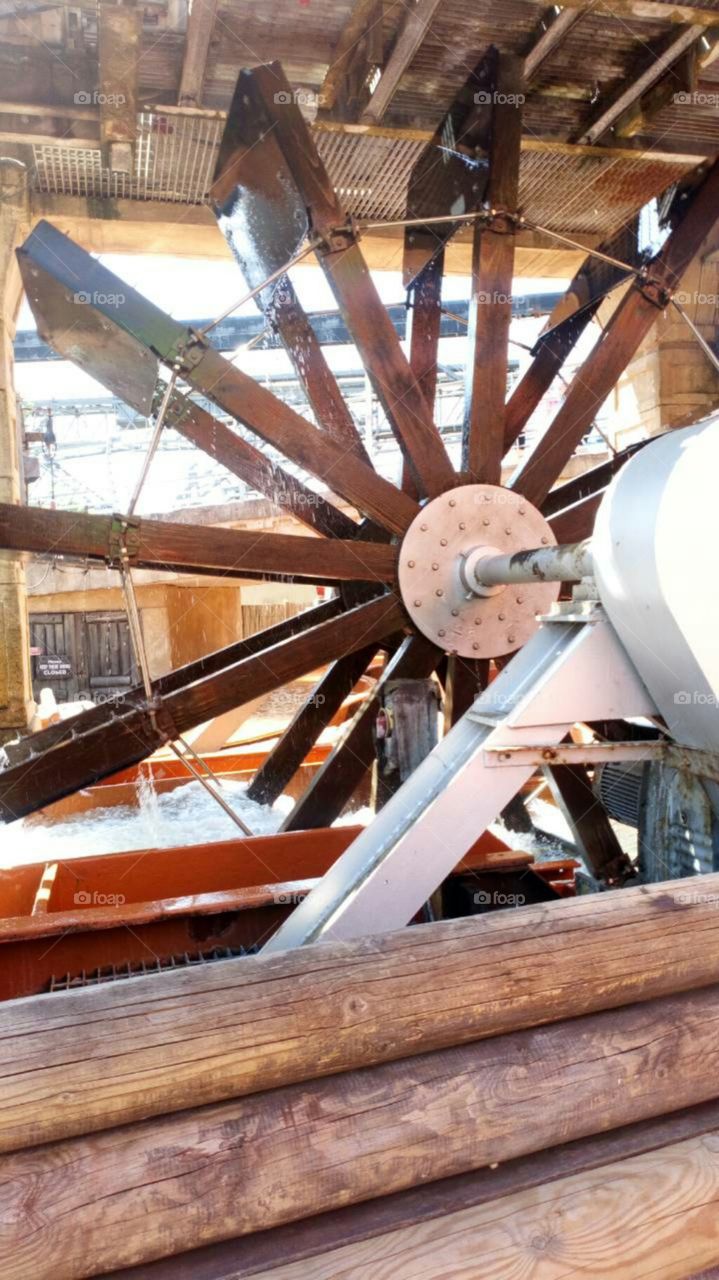 Water powering a wheel for a log flume ride.