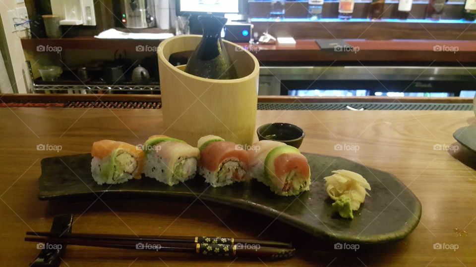 Rainbow roll Japanese food with hot sake one again I took this picture from my Samsung Galaxy Edge 6
