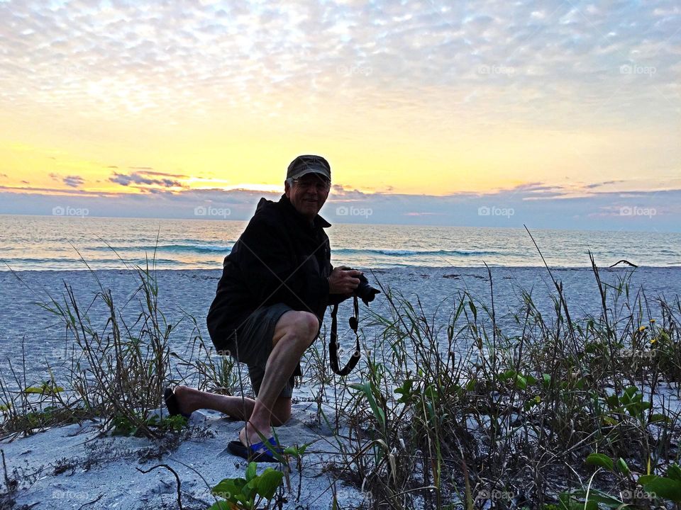 Portrait of a photographer on the beach.
