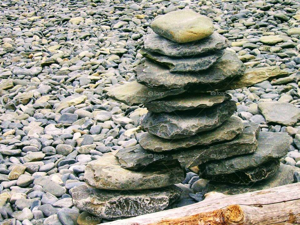 a stone Cairn on the seashore built by travelers