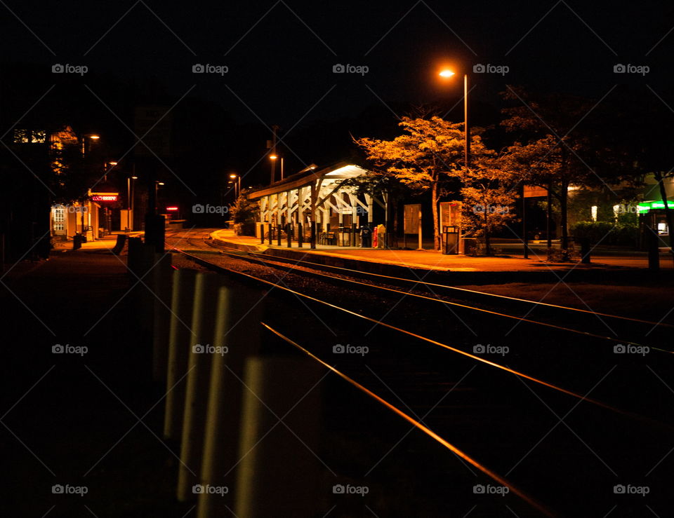 Late night on the train tracks. Shooting out from the dark toward the station .