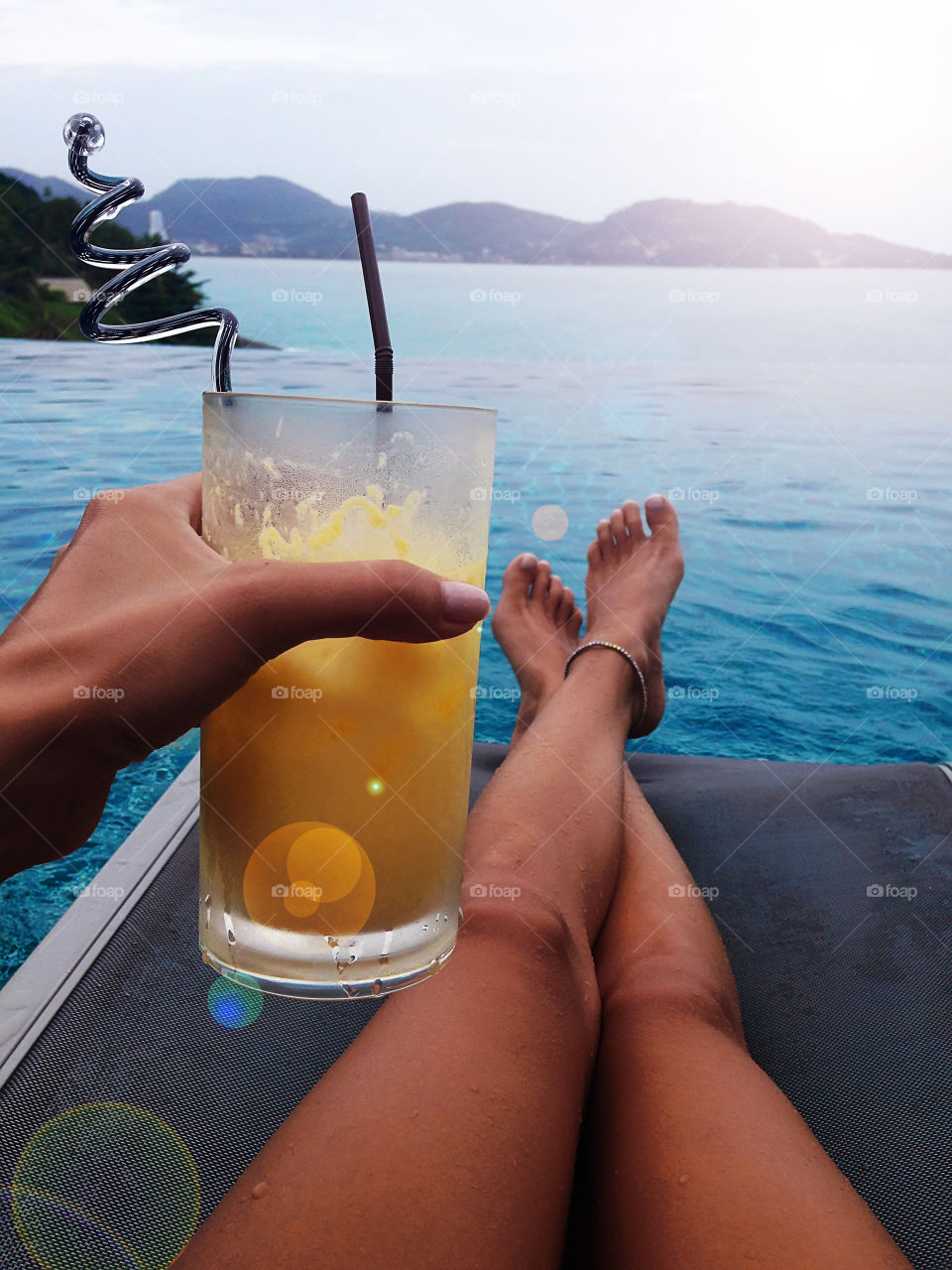 Toasting with a tropical pineapple cocktail at swimming pool 