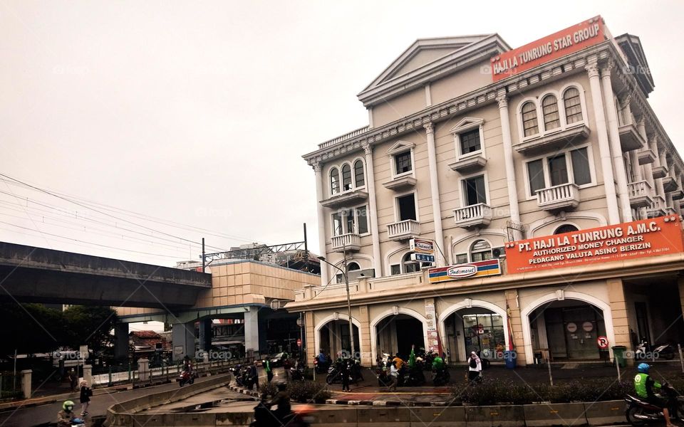 Photo of an old building by the side of a road