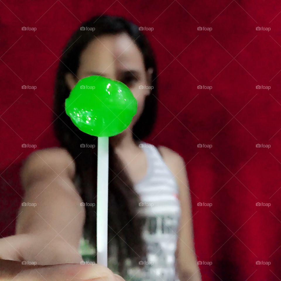 A woman holding a lollipop