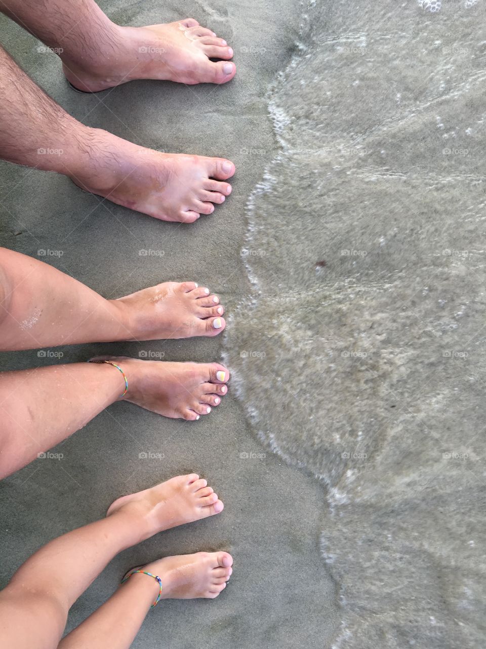 Family barefoot at the beach