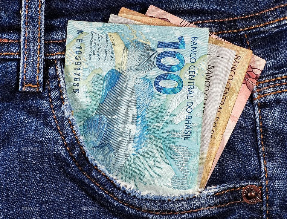money notes of 50 reais 100 reais and 200 reais from brazil in jeans pocket. space for text. money from brazil. earn money. Real, Currency, Money, Dinheiro, Reais, Brasil.