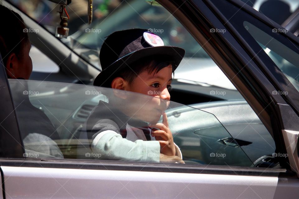 Boy is looking out of the car window