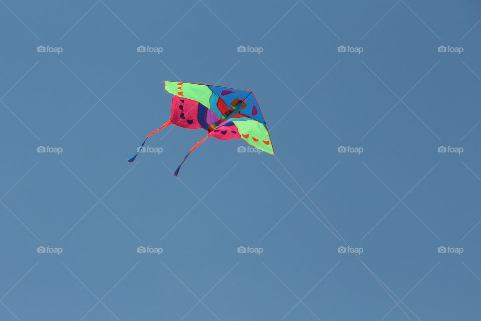 Flying colourful kite high in the sky