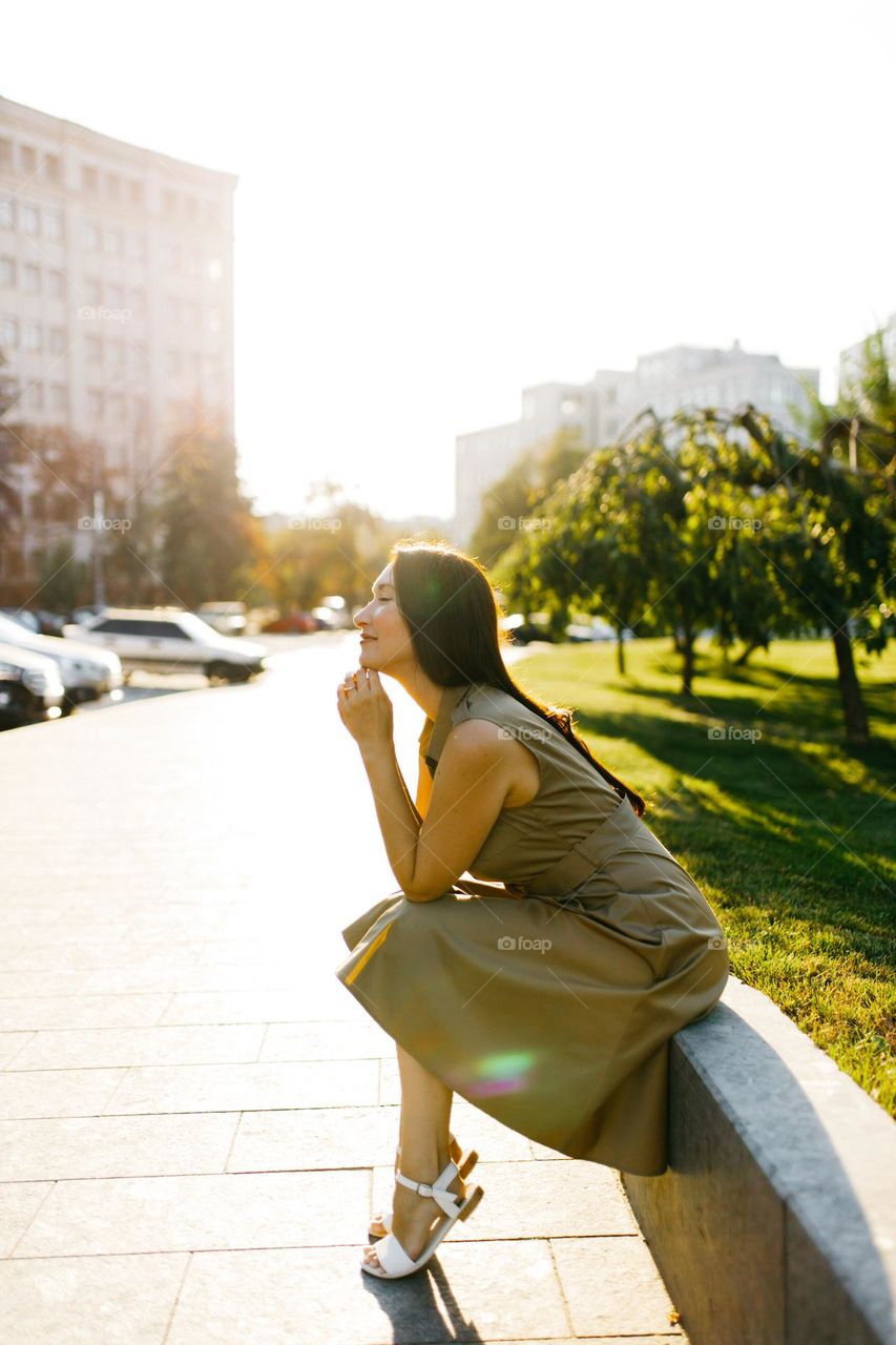 Girl in green dress relax in favorite city place