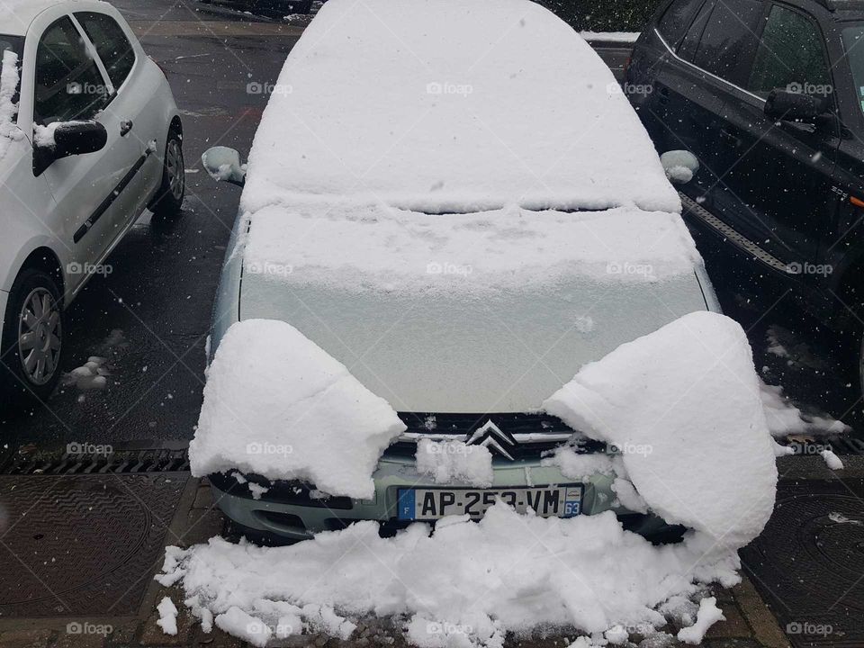 Car under the snow in Auvergne France