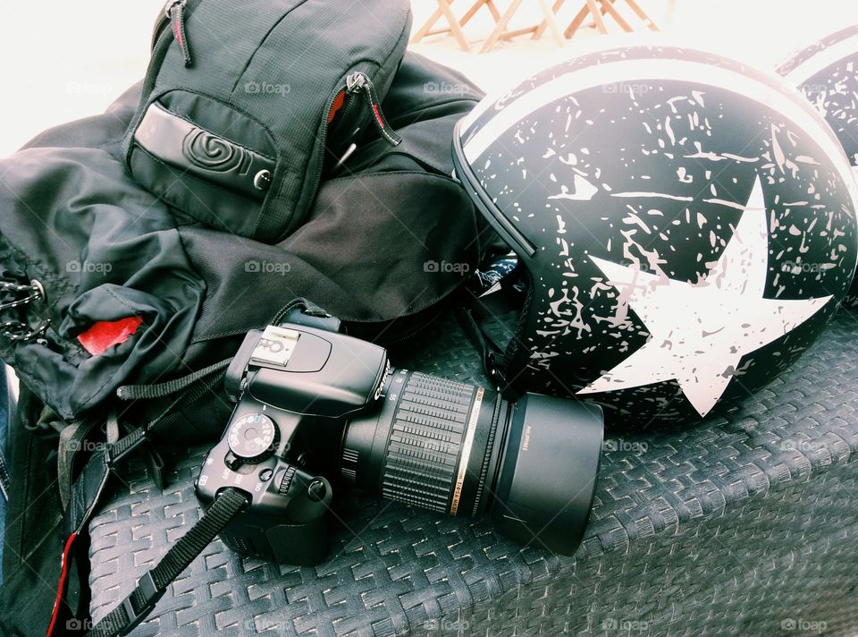 A camera, a backpack, a helmet