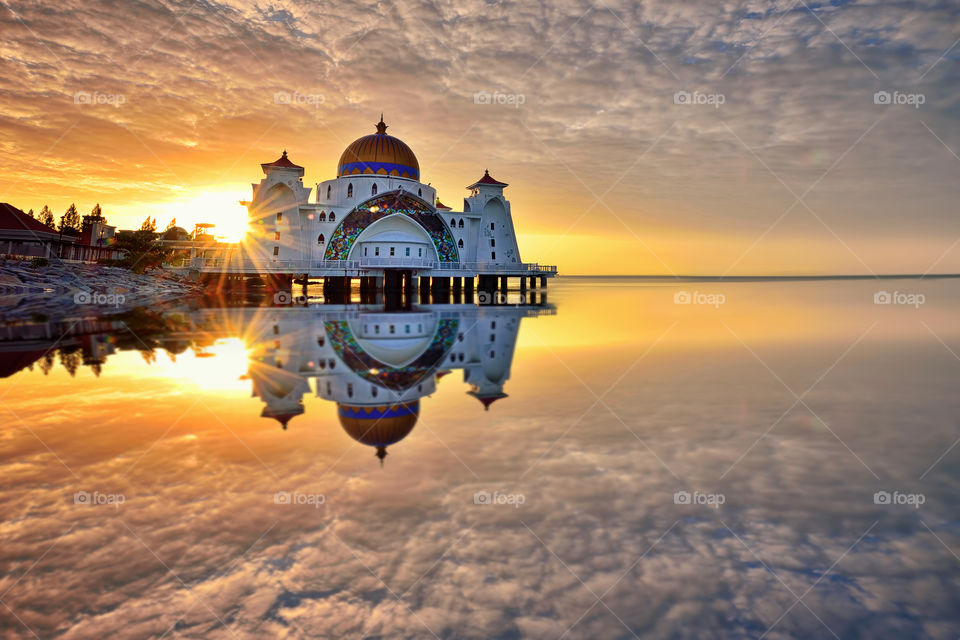Beautiful reflections during sunrise over Straits Mosque, Malacca
