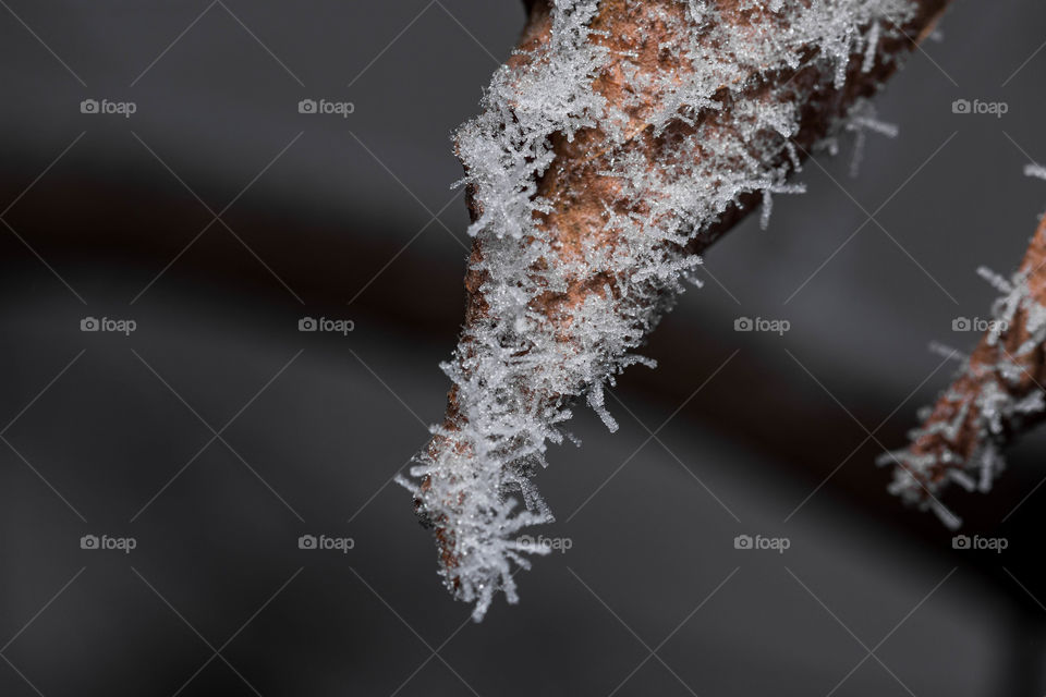 Frozen ice crystals on a piece of metal hanging