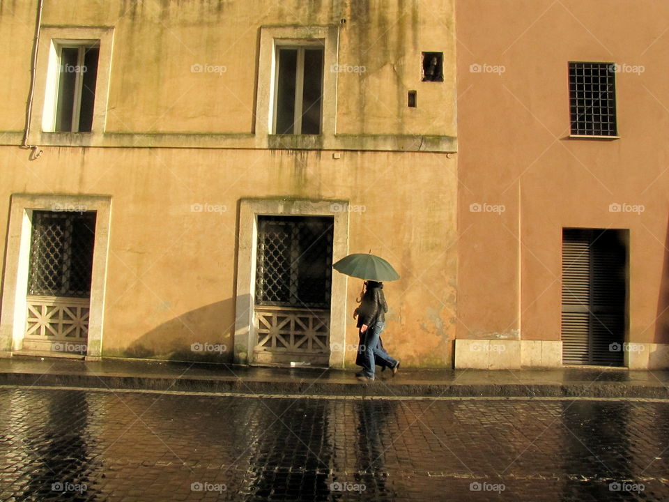 two walking after the rain with umbrella
