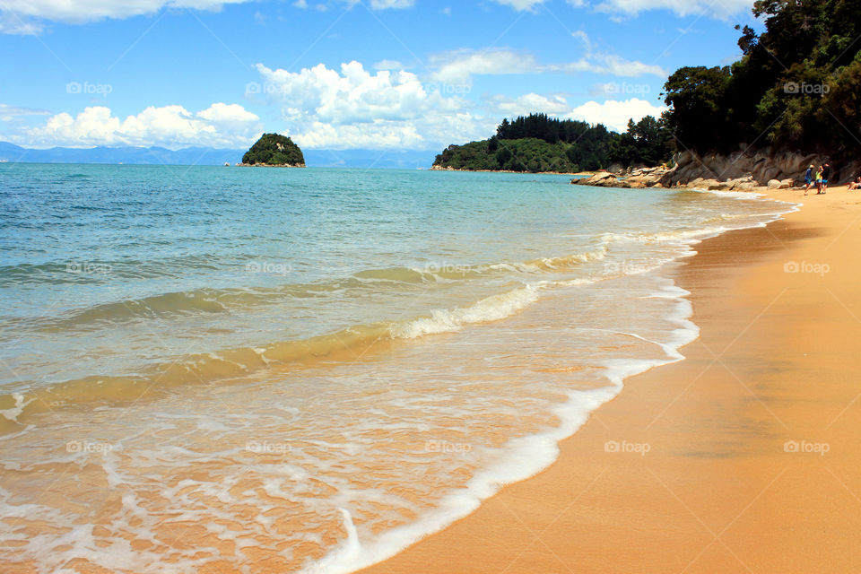 Beautiful beach against cloudy sky