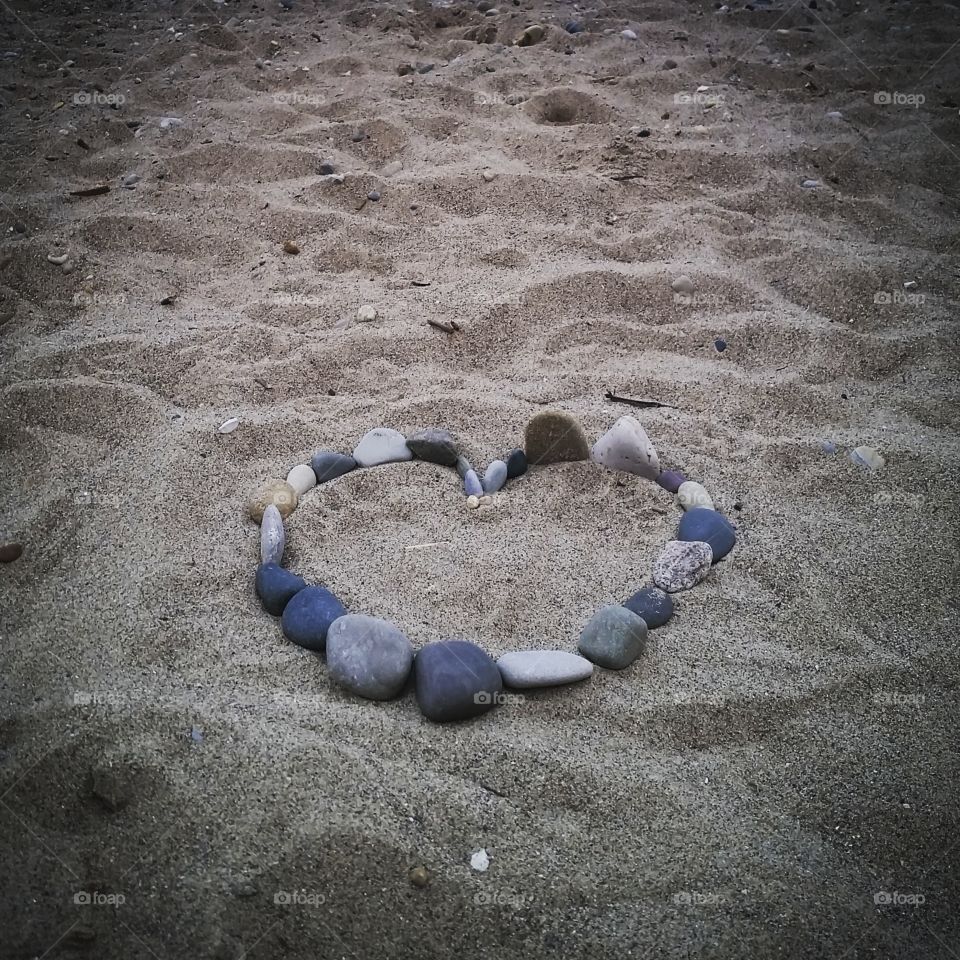 found heart. family camping and found these rocks placed into a heart on the beach.  lake huron, MI
