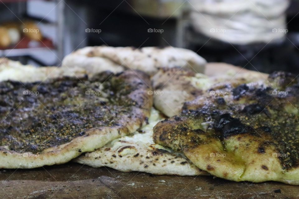 Fresh pita bread with Zaatar herb spice in bakery
