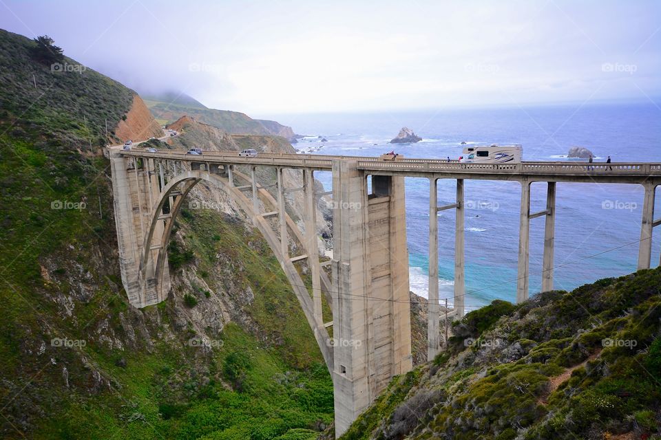 Holidaymakers and regular traffic crossing the iconic Bixby Bridge on highway 1 in California 