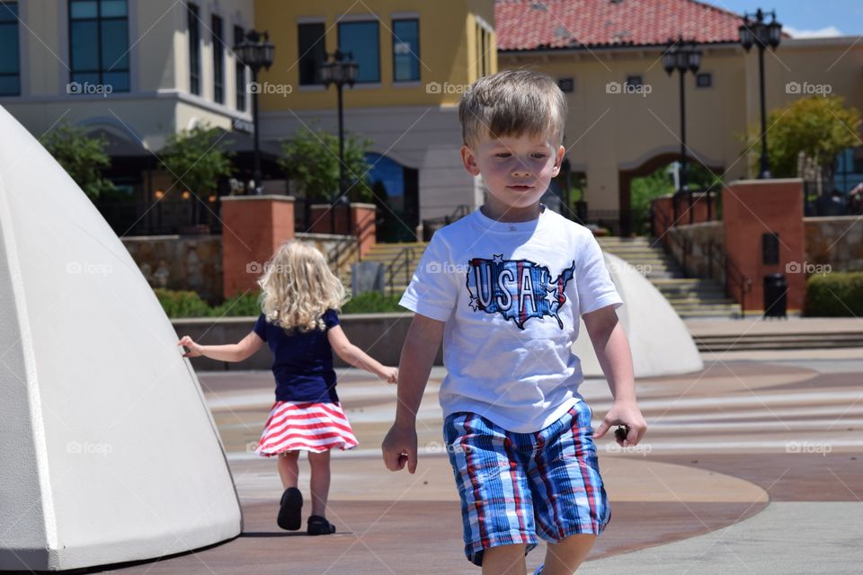 Siblings outside. Twins at outdoor mall