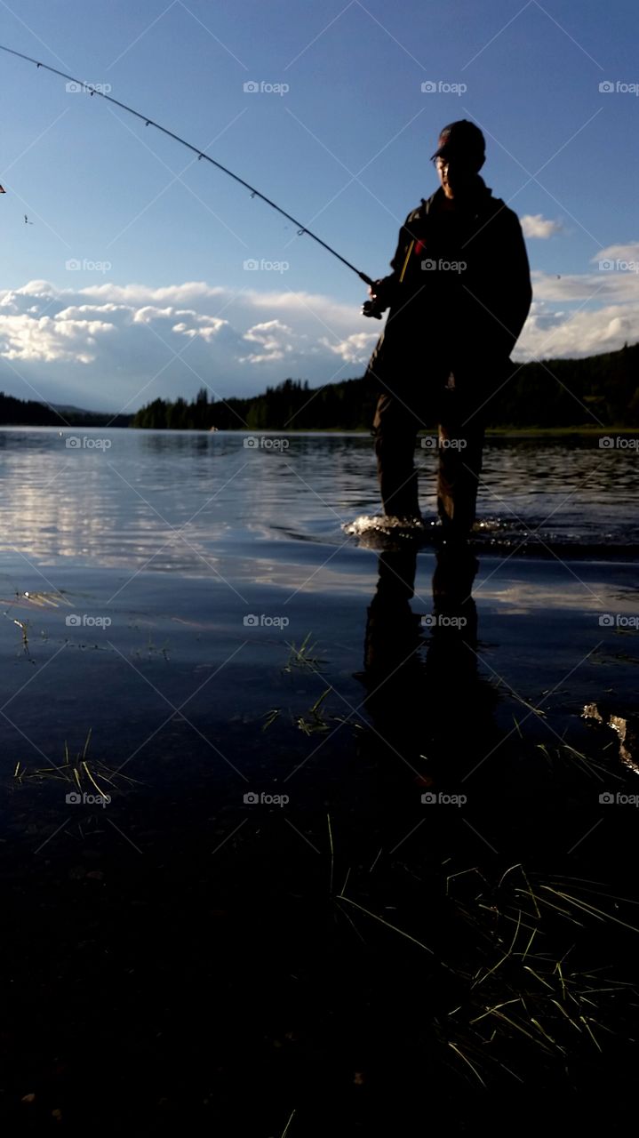 Man holding fishing hook in hand