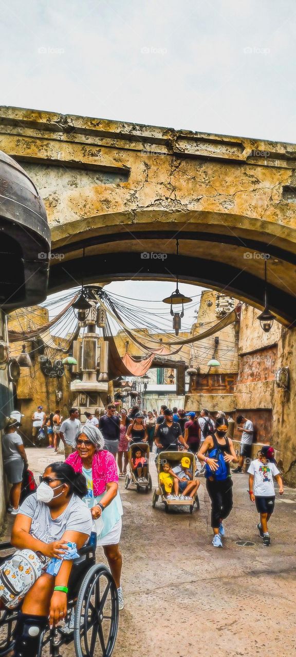 A rustic looking bridge in universal studios Orlando Florida a large cloud and many decorative features make a wonderful state of being 