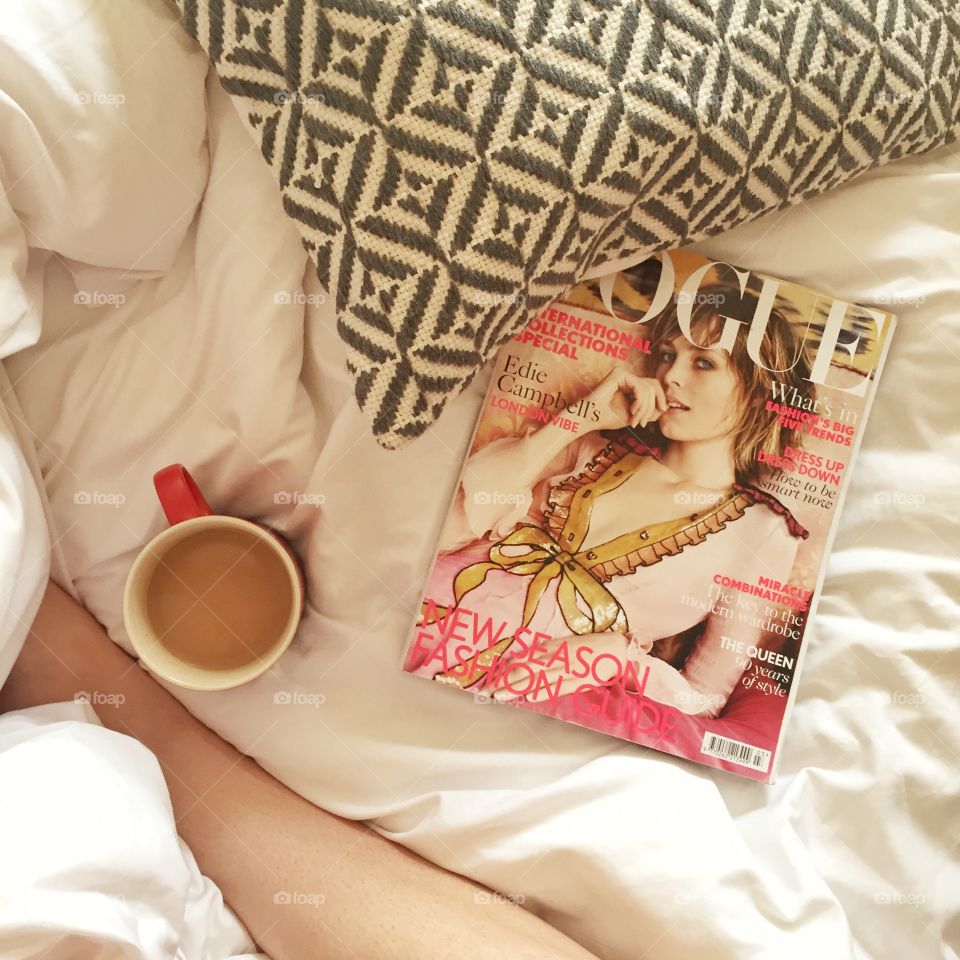 Cosy weekend lie in bed with coffee and vogue magazine. 