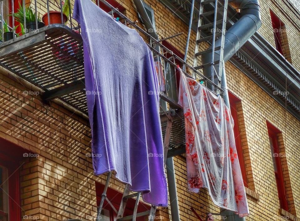 Laundry Hanging Out To Dry On A Fire Escape. Laundry Hanging To Dry On An Urban Balcony
