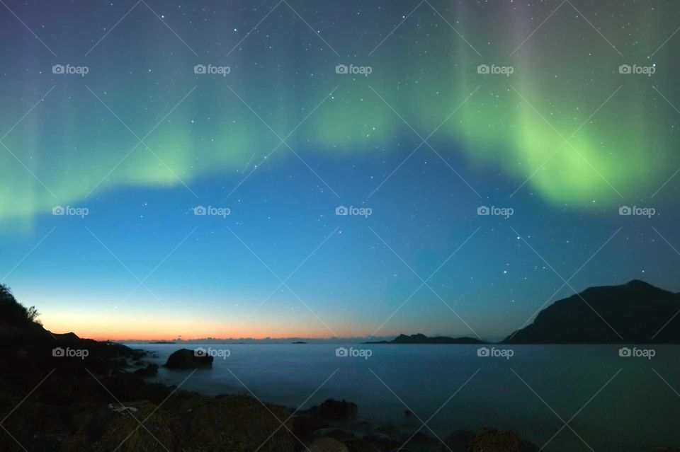 Aurora at dawn. Aurora Borealis at dawn. Northern Norway, Kvaløya.