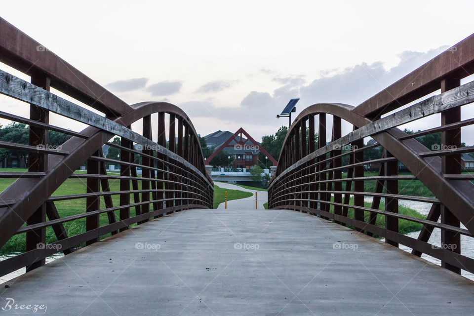 Bridge... While walking a park, I came across a beautifully constructed bridge leading to lovely clouds.