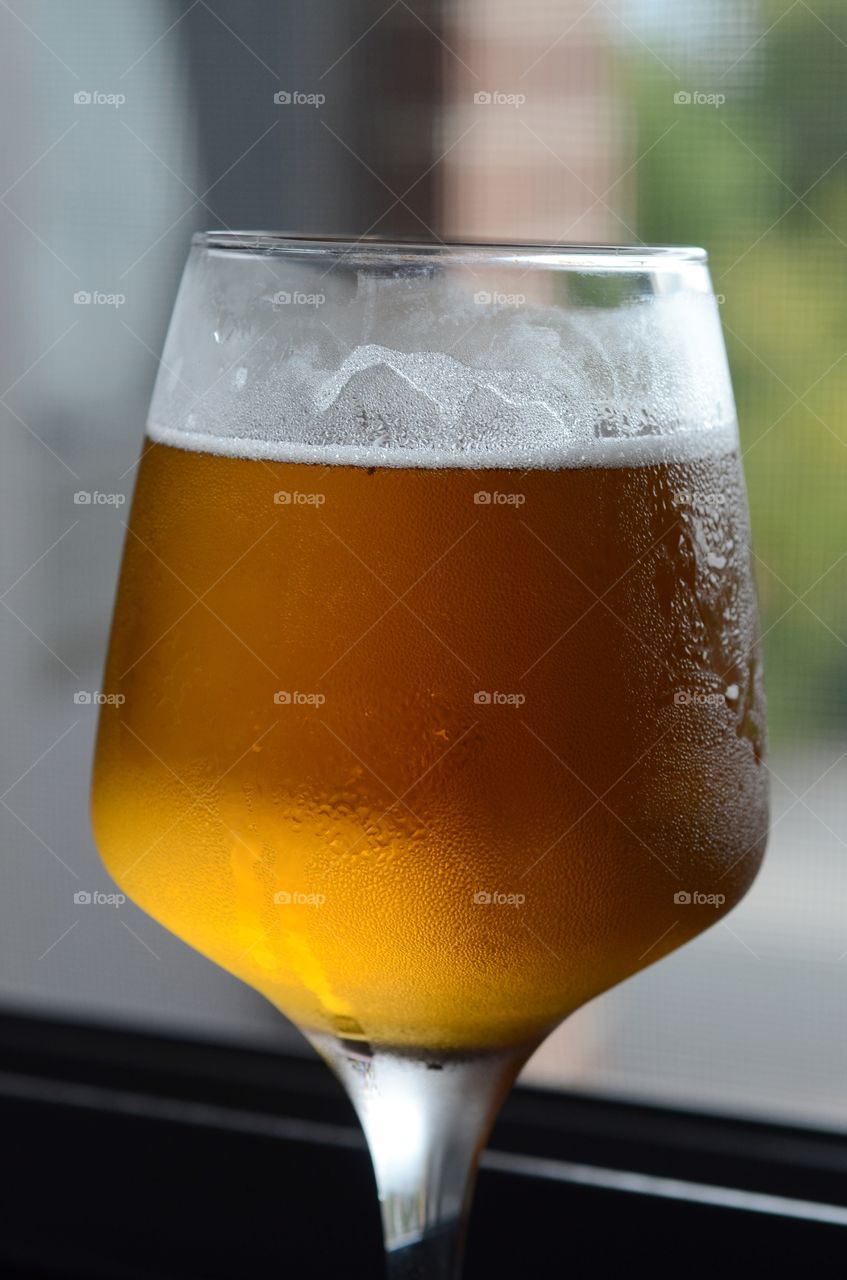 A closeup of a cold glass of beer.