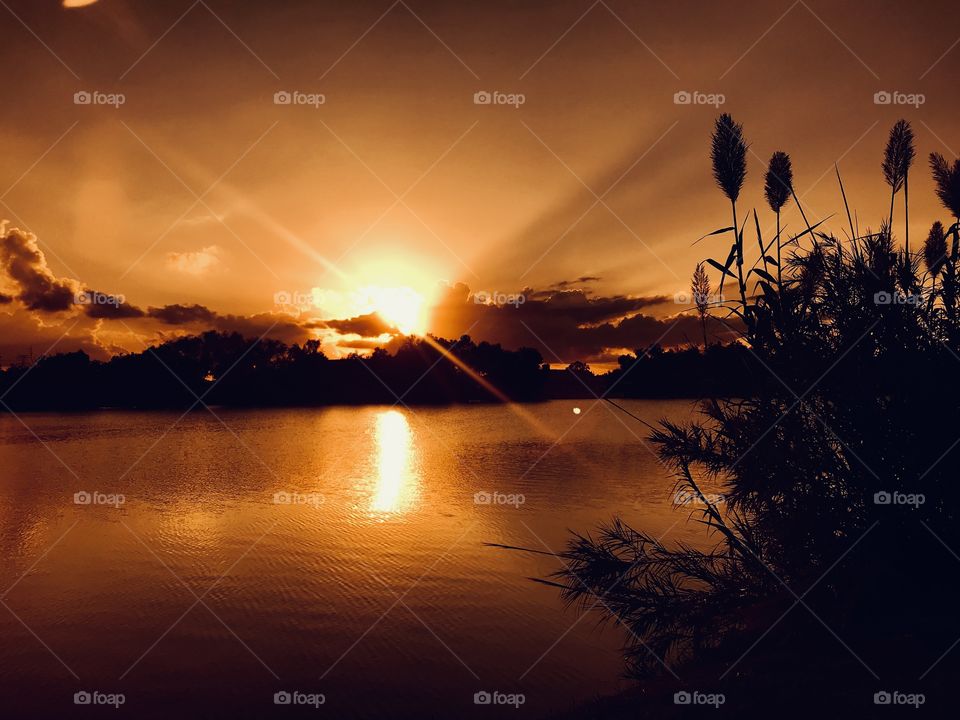 Watching this sunset predicting the set point. Not anticipating heavy clouds moving in but overall pic looks very well. Clouds, Sun Glow, Sun Trail, are Evidence of a Beautiful Sunset