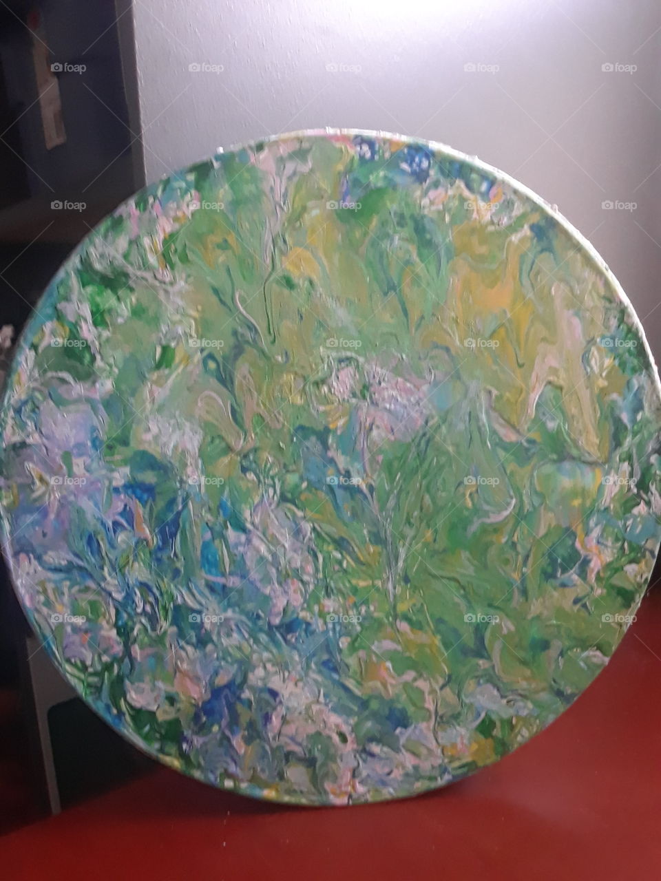 Acrylic painting on round surface with a springtime image.
