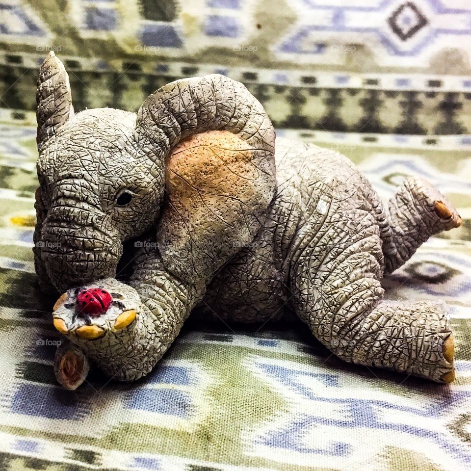 A 69¢ figure of an elephant with hanging out with his friend ladybug.