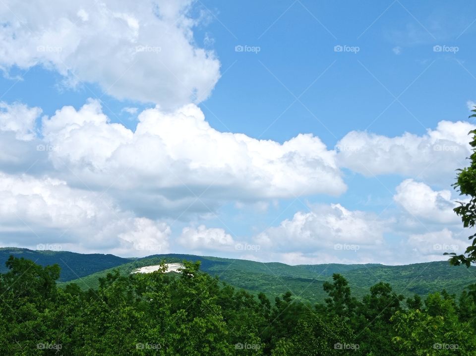 View from the mountain. Flying clouds. Forest and mountains. Nature.