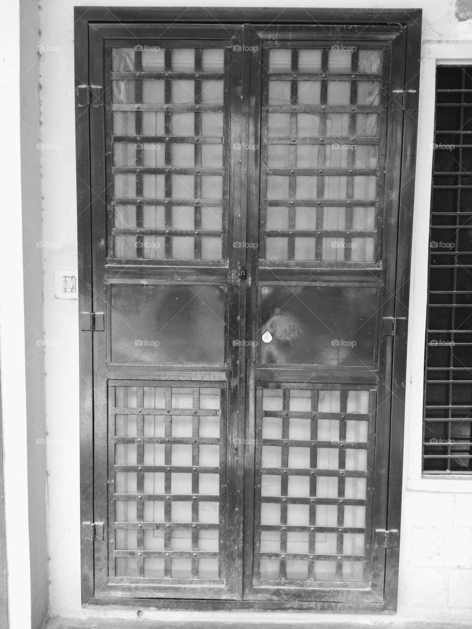 a iron door with the mosquito mesh