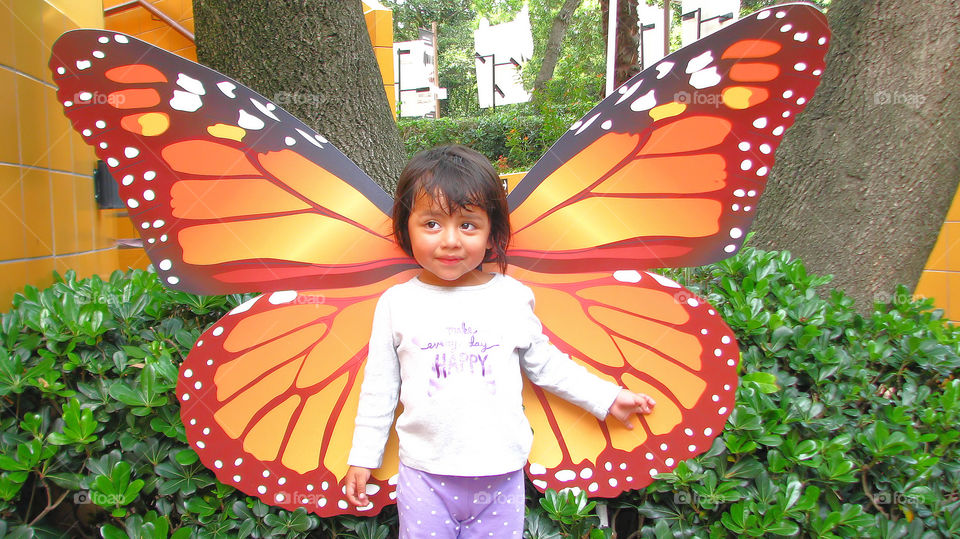 Close-up of a cute girl with butterfly wing