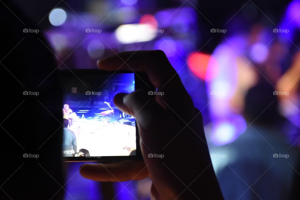 snapping a photo in a concert 
