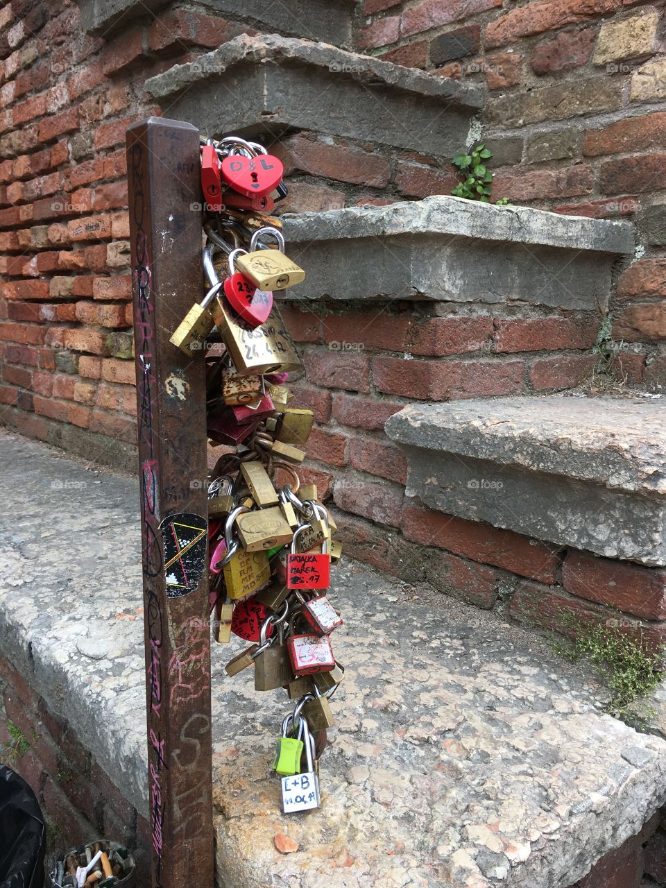 Verona Italia 

A Chain covered with Locks and Hearts,
With Love and Cruel 

This chain is locked on Bridge,
on Ponte di Castelvecchio 