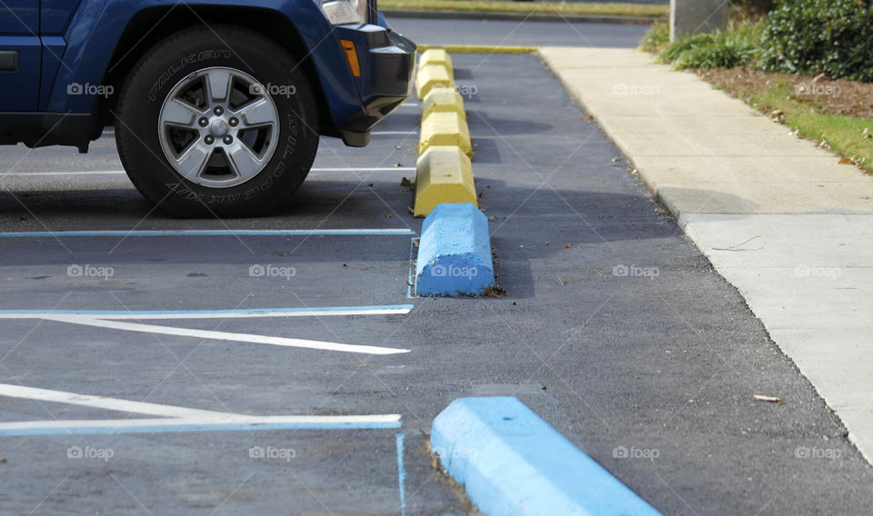 Concrete automobile bumpers in a parking lot for handicap parking