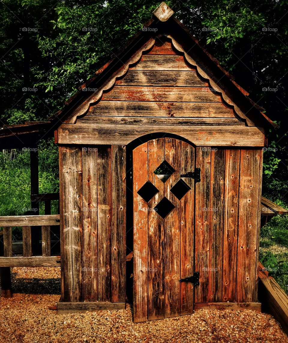 Wooden playhouse near a forest—taken in St. John, Indiana 